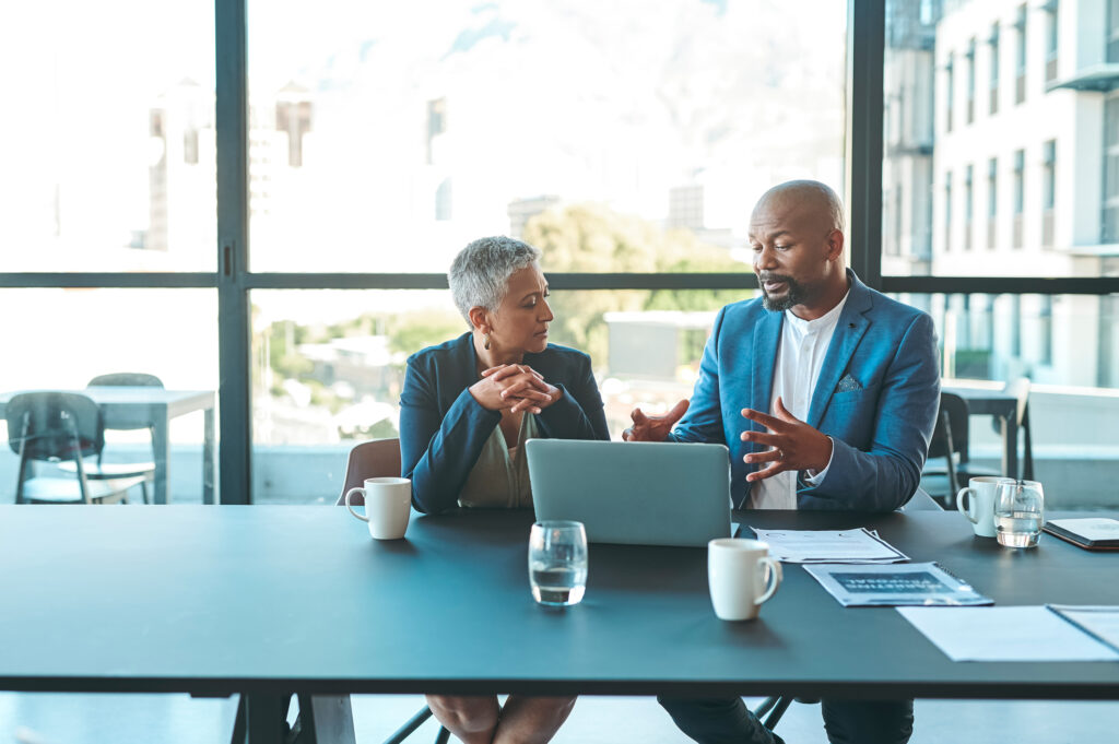 Business, presentation and man on a laptop in a corporate conference or office collaboration with a donor at work