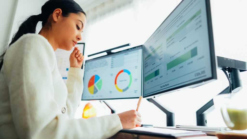 woman working on data at a computer