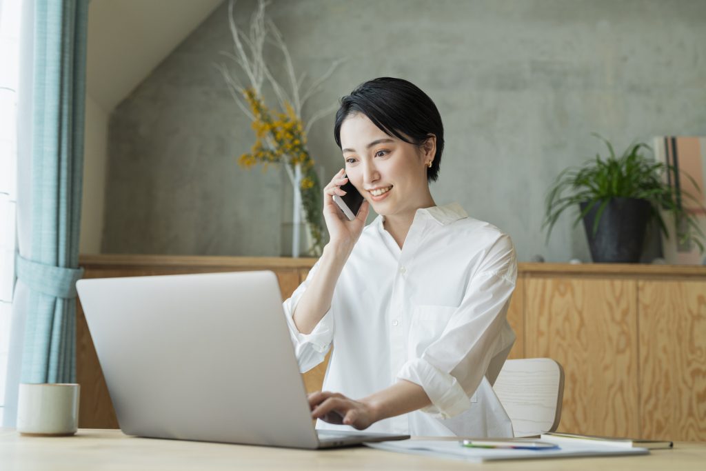 A woman on the phone while working remotely